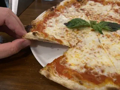 Crust close-up of pizza at Via Emilia