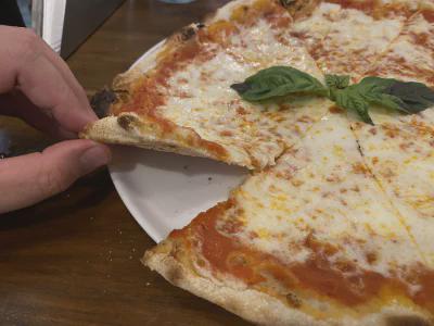 Crust close-up of pizza at Via Emilia