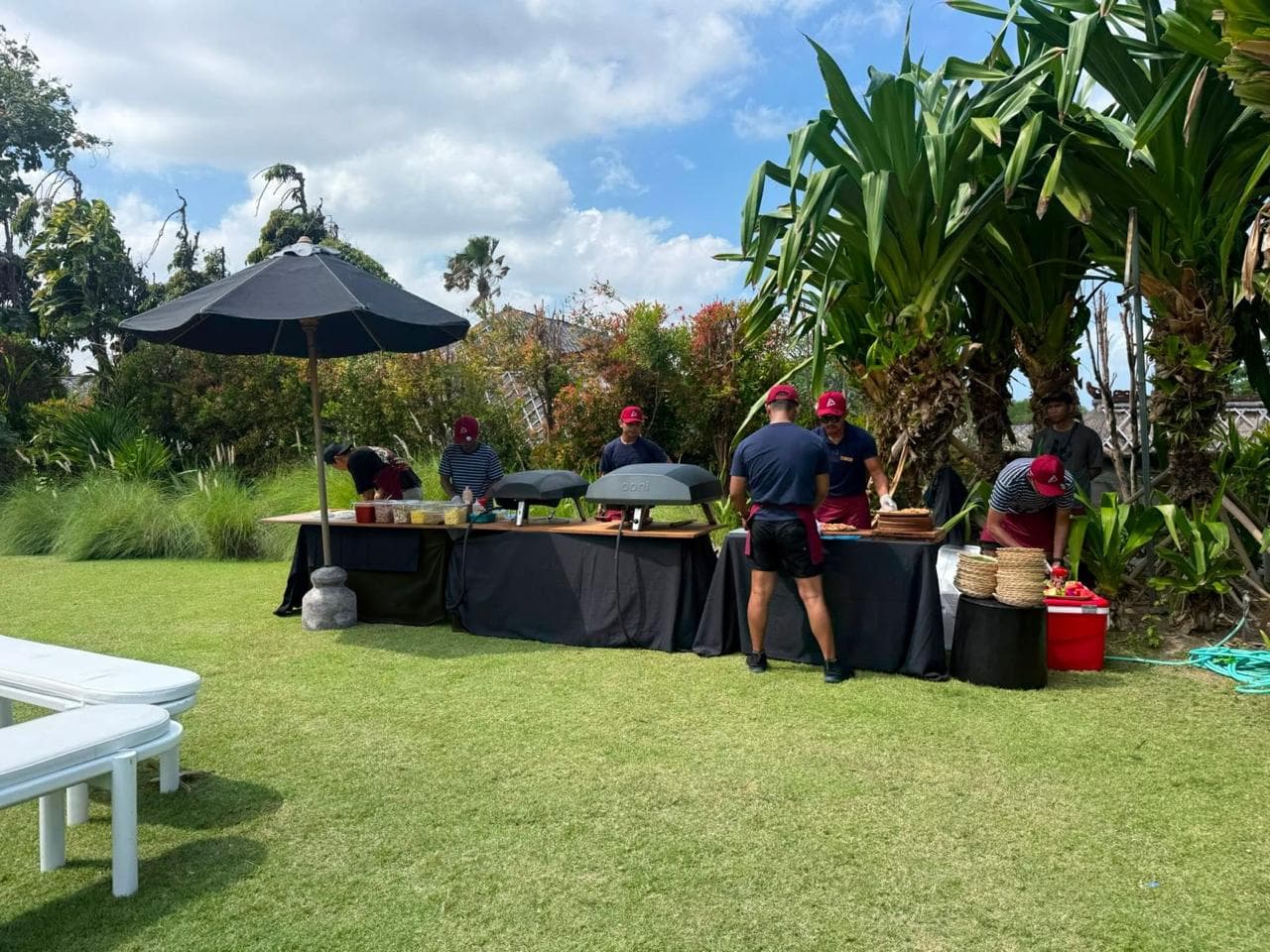 Our full pizza station set up at a villa, with two Ooni ovens and the crew ready to cook