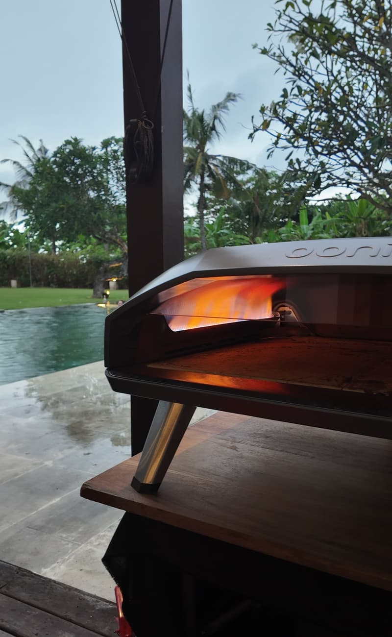 The oven lit under the pergola by the pool at Shalimar Villas at dusk