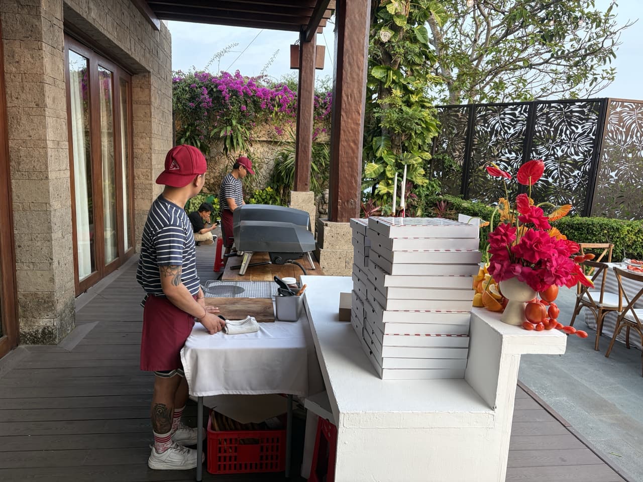 Our crew at the prep table under the terrace at Stone Villas, bougainvillea behind