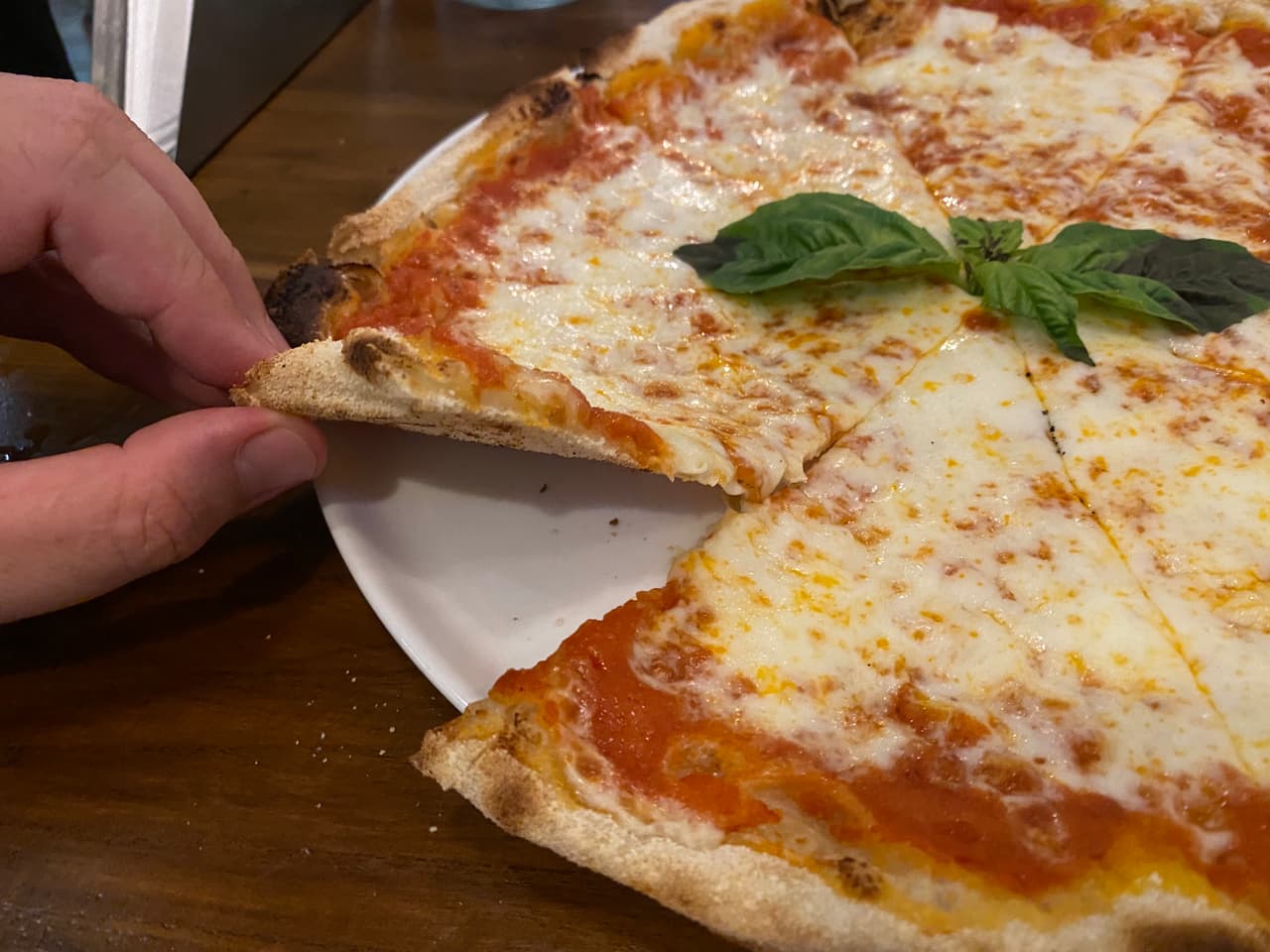Crust close-up of pizza at Via Emilia